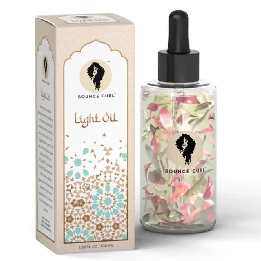 Bounce Curl Light Oil with floral petals in glass bottle and patterned box for curly hair care