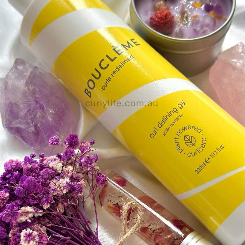 Yellow Bouclème curl defining gel with dried flowers and crystals, plant-powered curl care