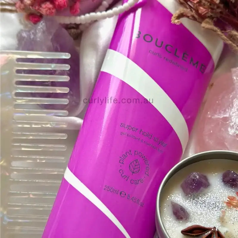 Bouclème Super Hold Styler for curly hair, plant-powered curl care with purple packaging and styling tools