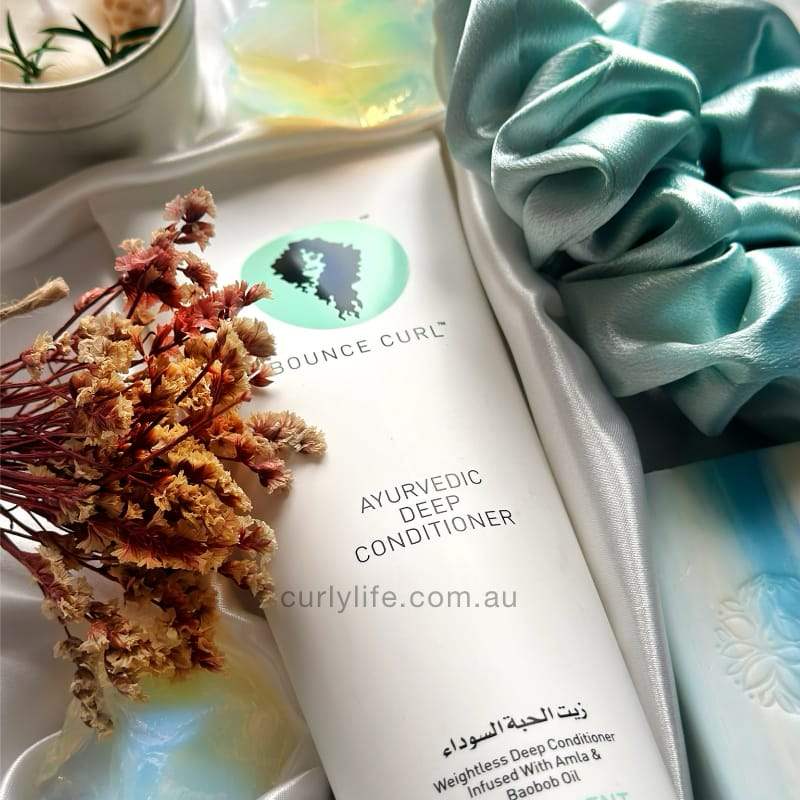 Bounce Curl Ayurvedic Deep Conditioner with silk scrunchie and dried flowers, perfect for curly hair care
